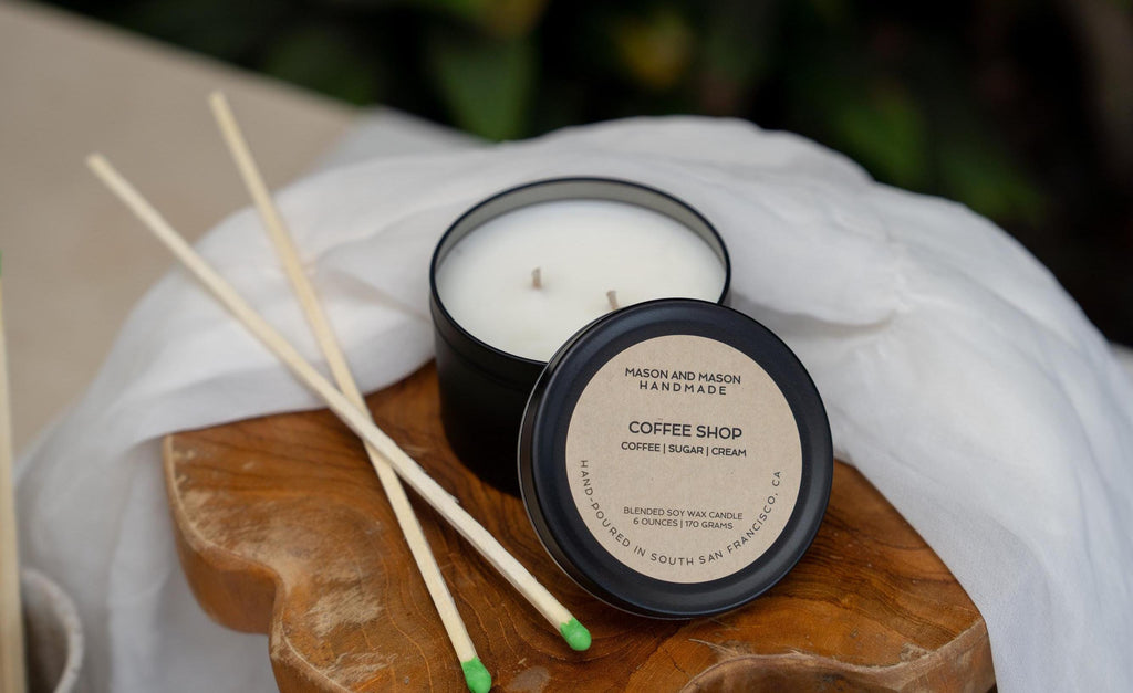 Candle with wooden match sticks on a wooden board with a white cloth background