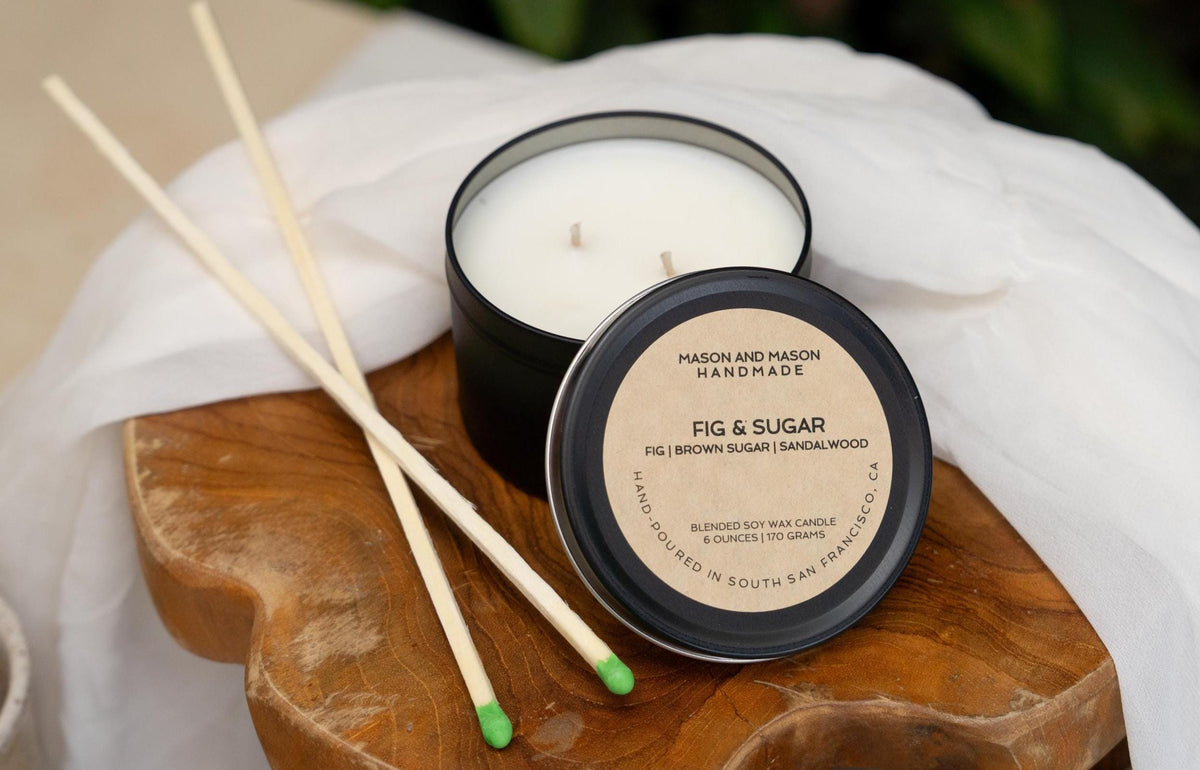 Candle with wooden match sticks on a wooden board