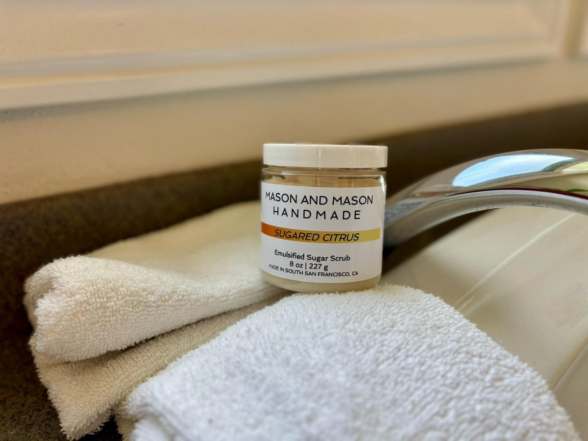 Jar of Mason and Mason Handmade Sugared Citrus scrub on a towel with a shower in the background